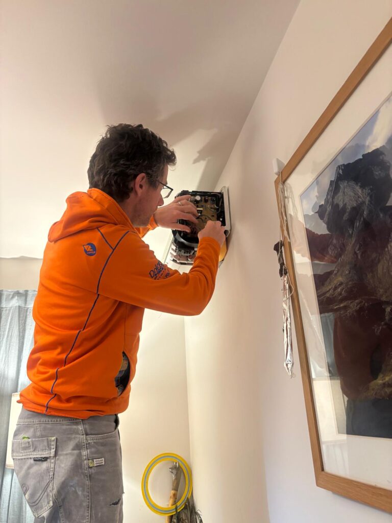 Tinkering with the indoor unit to install the remote thermostat link.